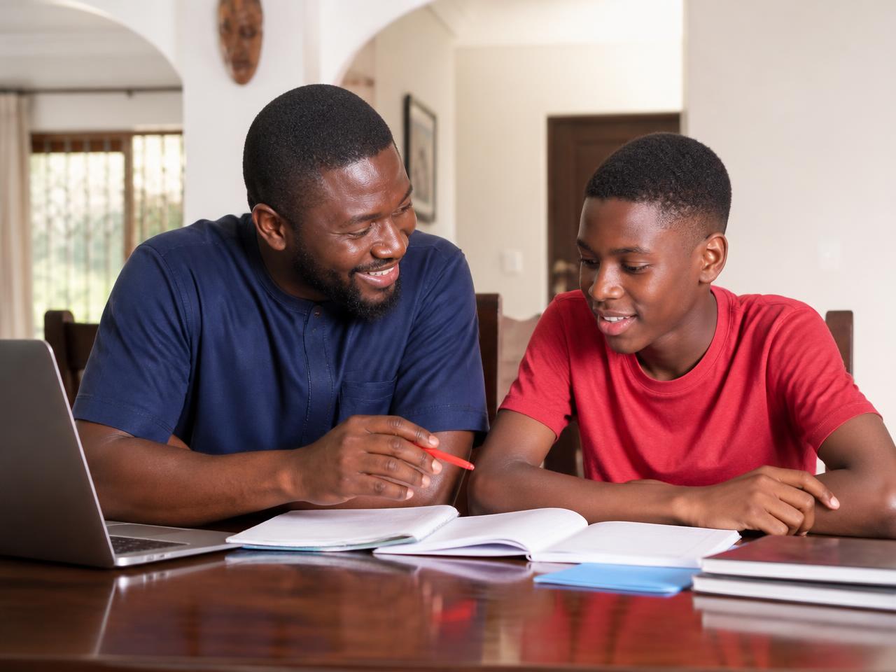 A tutor teaching a student at home in Ghana